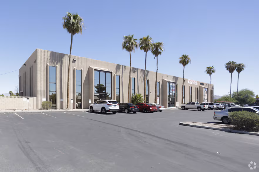 Exterior of the building at 4080 E Lake Mead Blvd, with tall windows and palm trees